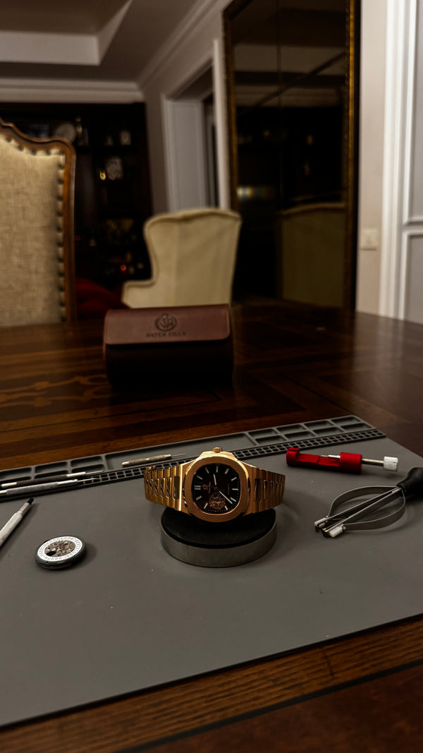 The finished watch on its stand at the bench, face up